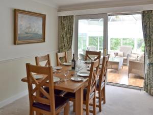 a dining room with a wooden table and chairs at Fairfield in Barrowford