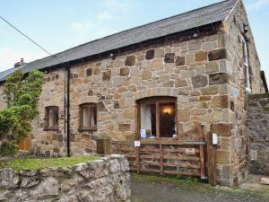 an old stone building with a wooden door at The Stables in Ball