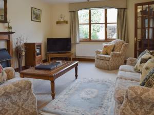 a living room with a couch and a coffee table at Russet Cottage in Moreton in Marsh