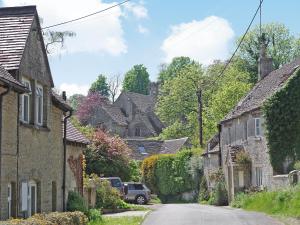 an empty street in a village with houses at Ivy Cottage in Chedworth