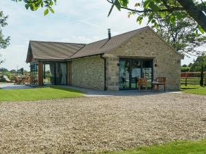 a stone house with a circular driveway at Puddledock Piggery in Berkley