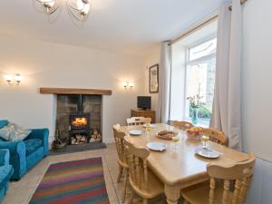 a dining room with a table and a fireplace at Tinakori in Staithes