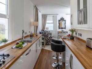 a white kitchen with a sink and a counter top at Babbacombe Bay, Torquay in Torquay