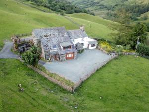 an aerial view of a large house on a hill at Oak Cottage in Ambleside
