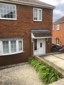 a red brick house with a white door at High rd hideaway in Warmsworth