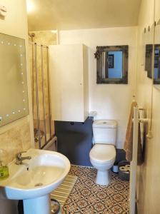 a bathroom with a toilet and a sink at Woodworth Cottage in Barnoldswick
