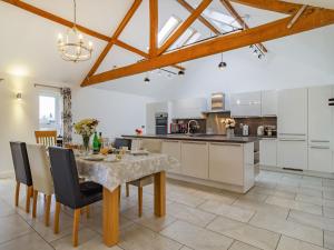 a kitchen with a table and chairs and a dining room at Barrow Barn in Wicken
