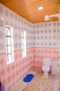 a bathroom with a toilet and a window at Hope Homestay in Syokimau