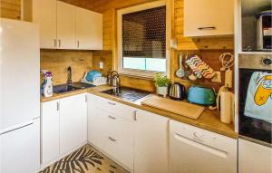a kitchen with white cabinets and a sink at Nice Home In Morag With Sauna, Wifi And 5 Bedrooms in Morąg