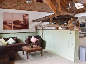 a living room with two couches and a table at The Chaff House in Arlingham