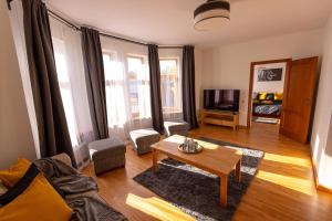 a living room with a couch and a coffee table at Priedes māja in Ainaži