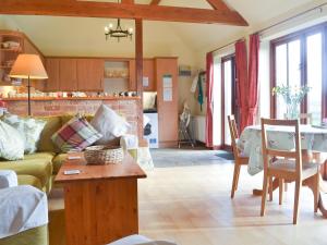 a living room with a couch and a table at Hog Pits in Tytherton Lucas