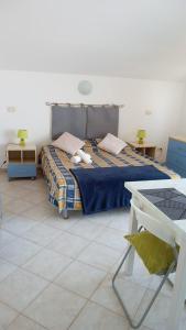 a bedroom with a bed with two stuffed animals on it at Santa Maria flats in Santa Maria