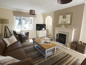 a living room with a couch and a table at The Retreat Lulworth in West Lulworth