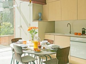 a kitchen with a table and chairs with orange juice at Smugglers Cottage in Margate