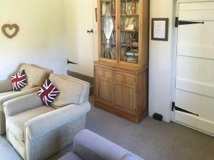 a living room with two chairs and a book shelf at Park House in Harlaxton