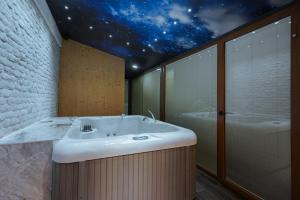 a bathroom with a sink and a starry ceiling at Bushi Resort & SPA in Skopje