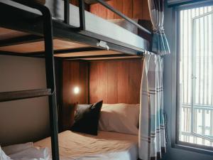 a bunk bed in a room with a bunk bedutenewayangering at Whereder Poshtel in Udon Thani