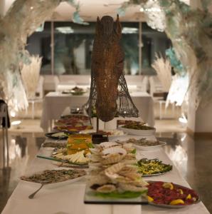 a row of plates of food on a table at Hotel Alexander Museum Palace in Pesaro