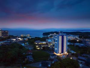 a view of a city at night with the ocean at クリスタルエグゼ南紀白浜2 in Shirahama