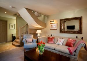 a living room with a couch and a chair and a mirror at The Crab & Lobster in Chichester
