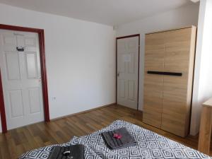 an empty room with a bed and a closet at 8888 Vendégház in Lispeszentadorján