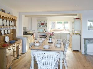 a kitchen with a table with dishes on it at Turnstone Cottage in Sheringham
