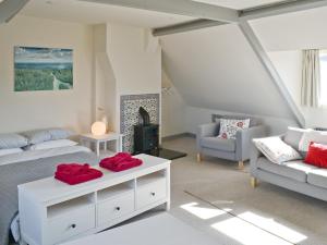 a living room with a bed and a couch at Turnstone Cottage in Sheringham