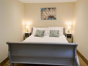 a bedroom with a large bed with two night stands at Whatley Lodge in Winsham