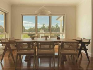 a dining room with a table and chairs and a window at The York Residence in Hartley NSW - Newly Listed in Hartley