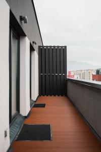 a balcony with a black door on a building at Skylark - Zurich Studio with Terrace & Mountain view in Braşov