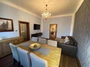 a dining room and living room with a table and chairs at Apartments 5 in the centre of Prague in Prague