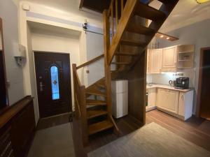 a stairway leading to a kitchen with a door at Apartments 5 in the centre of Prague in Prague