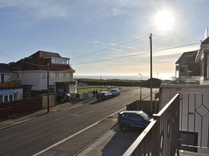 a street with cars parked on the side of the road at Pinecliffe Avenue in Southbourne