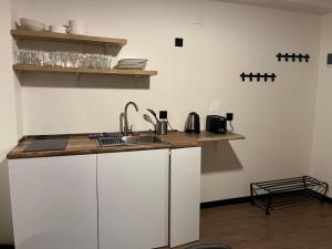 a kitchen with a sink and a counter top at ski retreat apt. with balcony in Gudauri