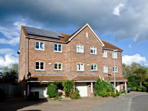 a large brick house with solar panels on it at Cormorant View in Weymouth