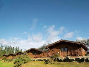 a large wooden house in the middle of a field at Lake View Lodges - 25076 in Leake Common Side