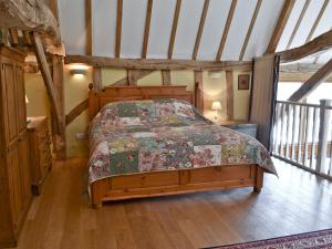 a bedroom with a bed in a attic at Rose Farm Barn in Laxfield