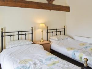 two beds sitting next to each other in a bedroom at Copper House - 18435 in Bempton
