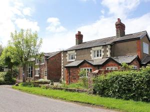 an old brick house on the side of a road at The Shippon in Burscough