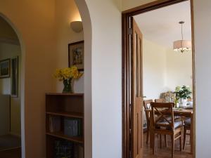 a hallway leading to a dining room with a table at Roundhill in Eydon