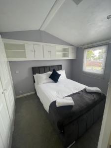 a bedroom with a bed in a small room at The Winchester Chalet by Sasco in Blackpool