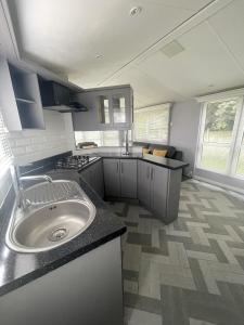 a kitchen with a sink and a counter top at The Winchester Chalet by Sasco in Blackpool