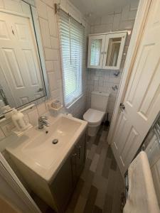 a white bathroom with a sink and a toilet at The Winchester Chalet by Sasco in Blackpool