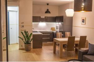 a kitchen and dining room with a table and chairs at Modern place-Top Bratislava location in Bratislava