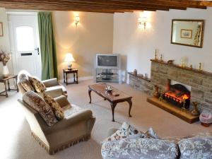 a living room with a couch and a fireplace at Bestdale in Frosterley
