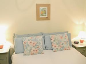 a bedroom with a bed with two pillows at Waterside in Bowness-on-Windermere