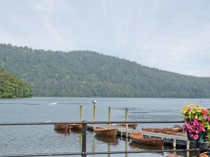a group of boats are docked on a lake at Waterside in Bowness-on-Windermere