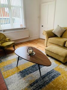 a living room with a coffee table and a couch at Elegant 3BD Edwardian Home Warminster in Warminster