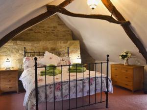 a bedroom with a bed in the attic at Bwthyn Barri in Sarnau